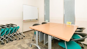 A conference room with a whiteboard, a clock, and a table with chairs. - Toyoko Inn Kagoshima Chuo-eki Nishi-guchi (KAGOSHIMA)