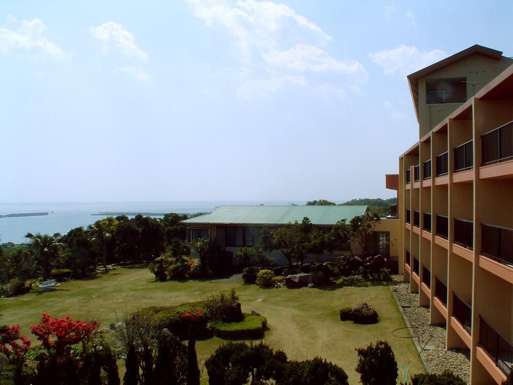 A building with multiple floors and a view of the sea.