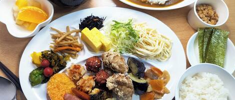 A variety of dishes including rice, soup, and assorted vegetables on a table.
