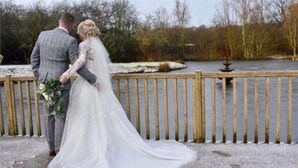 A couple standing by a wooden railing overlooking a body of water. - The Sitwell Arms Hotel (Sheffield)
