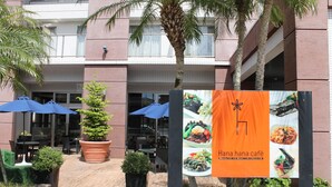 An outdoor café area with tables, umbrellas, and potted plants. - M's Hotel Clair Miyazaki (Miyazaki)