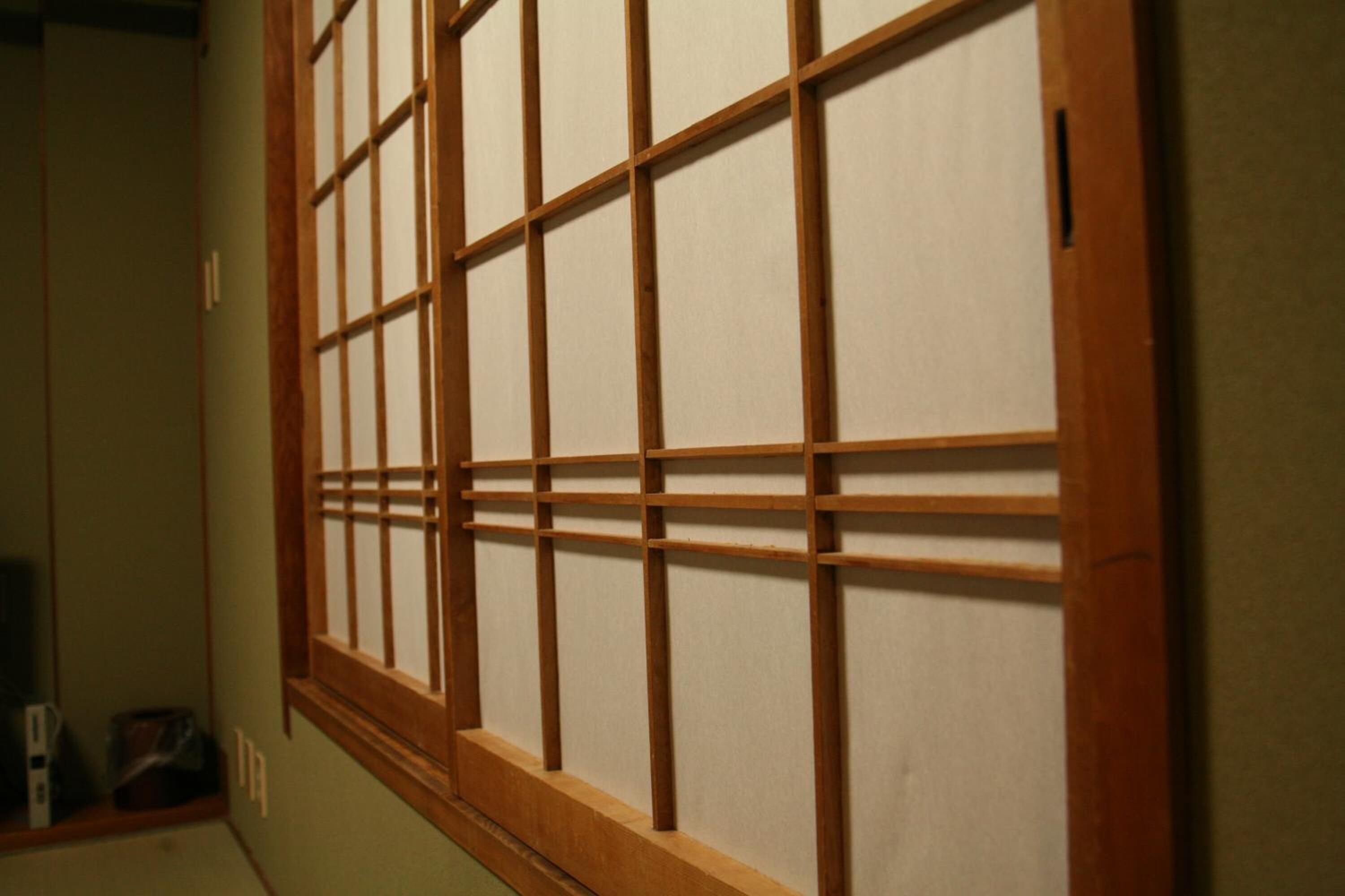 A traditional Japanese shoji screen with a wooden frame and translucent paper panels.