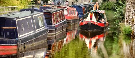 A narrow canal with boats docked along the sides.