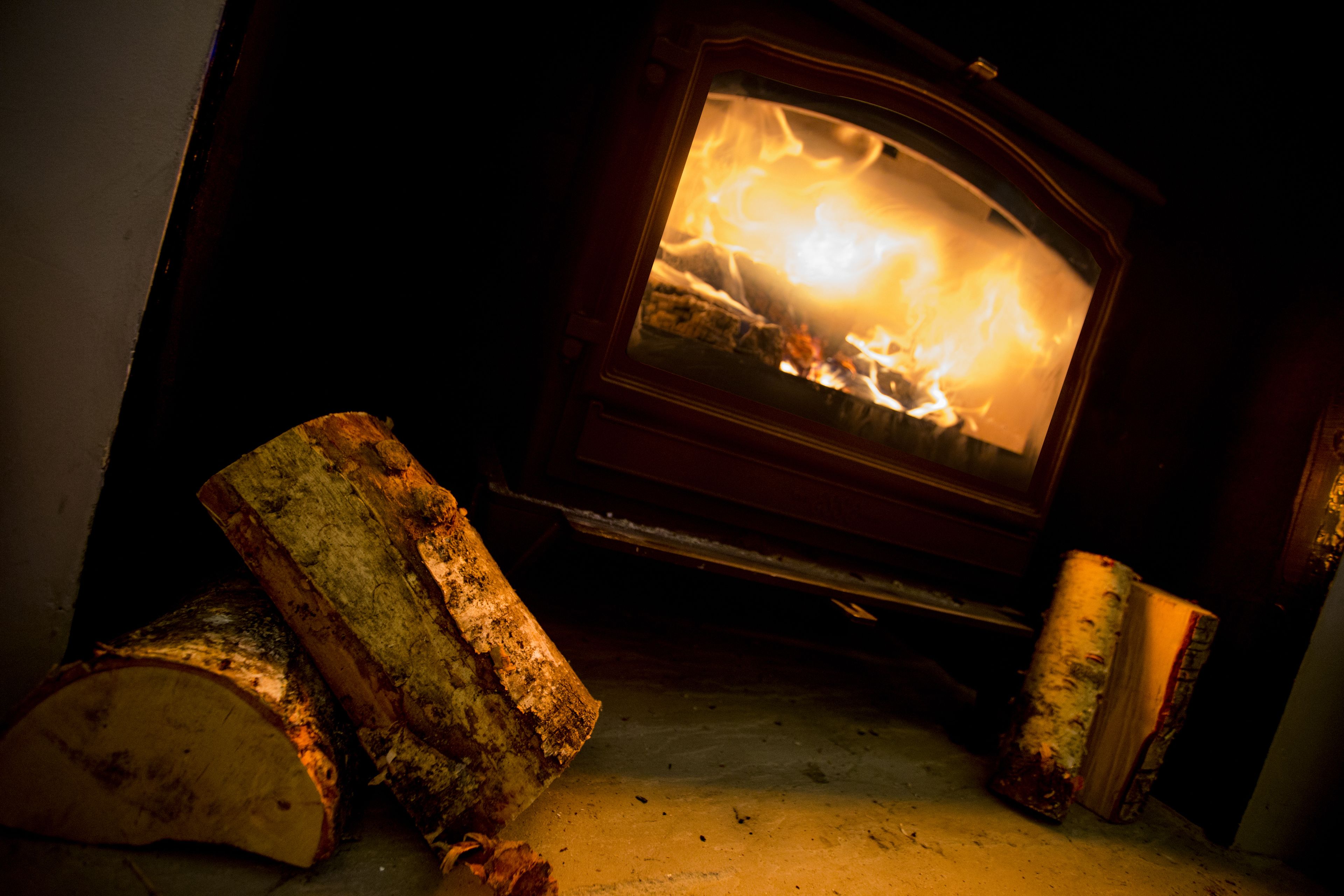 A fireplace with burning logs and a fire.