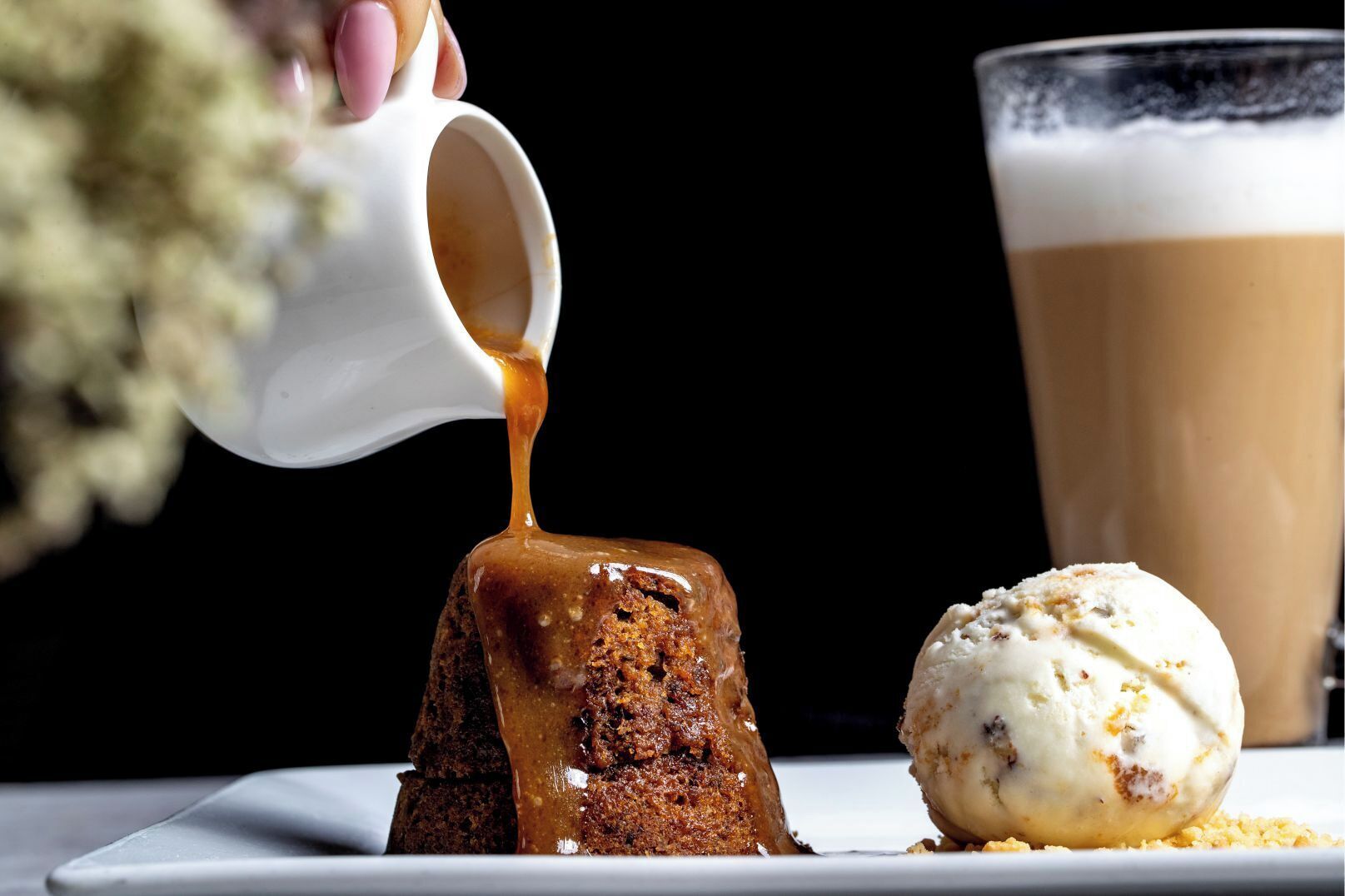 A dessert consisting of a caramelized pudding and a scoop of ice cream.