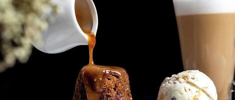 A dessert consisting of a caramelized pudding and a scoop of ice cream.