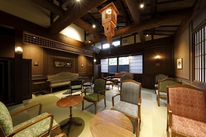 A traditional Japanese-style room with tatami flooring, wooden furniture, and shoji screens. - Kosumosu (Yufu)