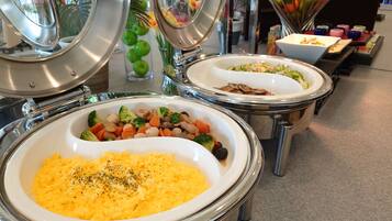 Buffet-style food stations with various dishes, including mashed potatoes and mixed vegetables.