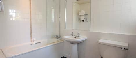 A modern bathroom with a bathtub, sink, and toilet.