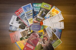 A variety of travel brochures and maps, including a Manchester map and a guide to Tarleton Park.
