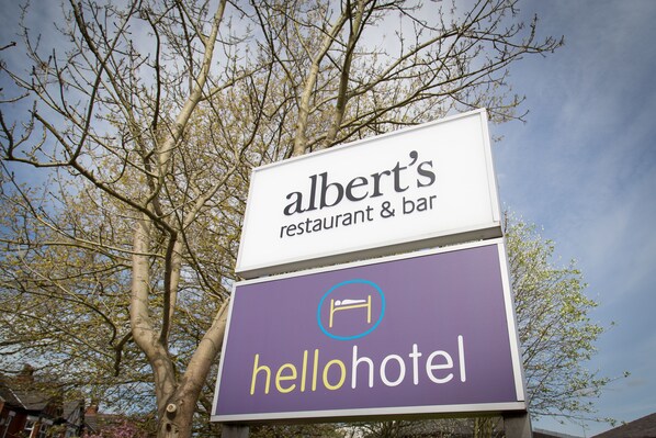 A sign for Albert's restaurant & bar and a hotel named HelloHotel.