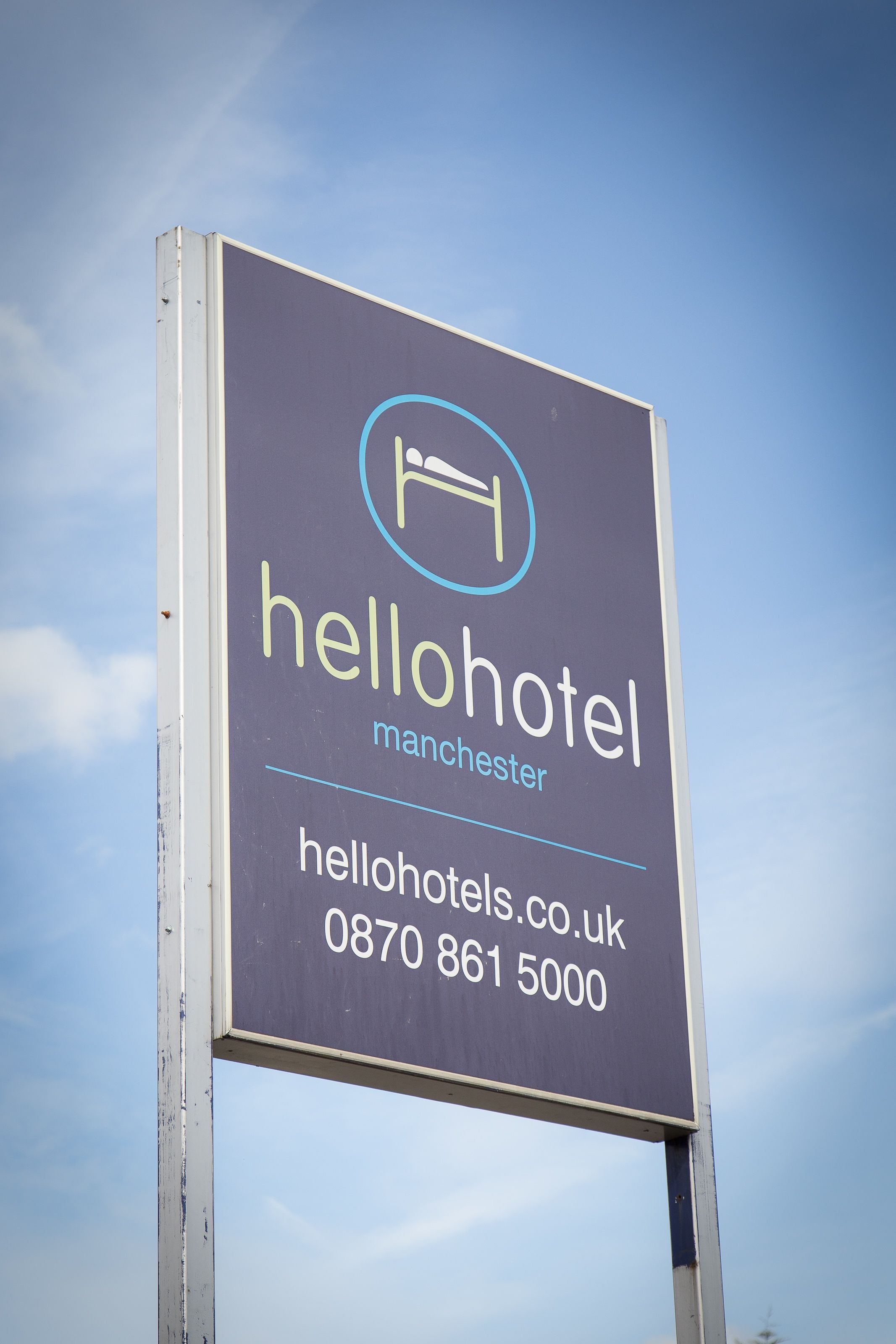 A hotel sign with the name "hellohotel" and the location "Manchester".