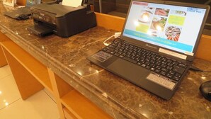 A laptop on a marble counter with a receipt printer and a menu display. - Toyoko Inn Aomori-eki Shomen-guchi (AOMORI)