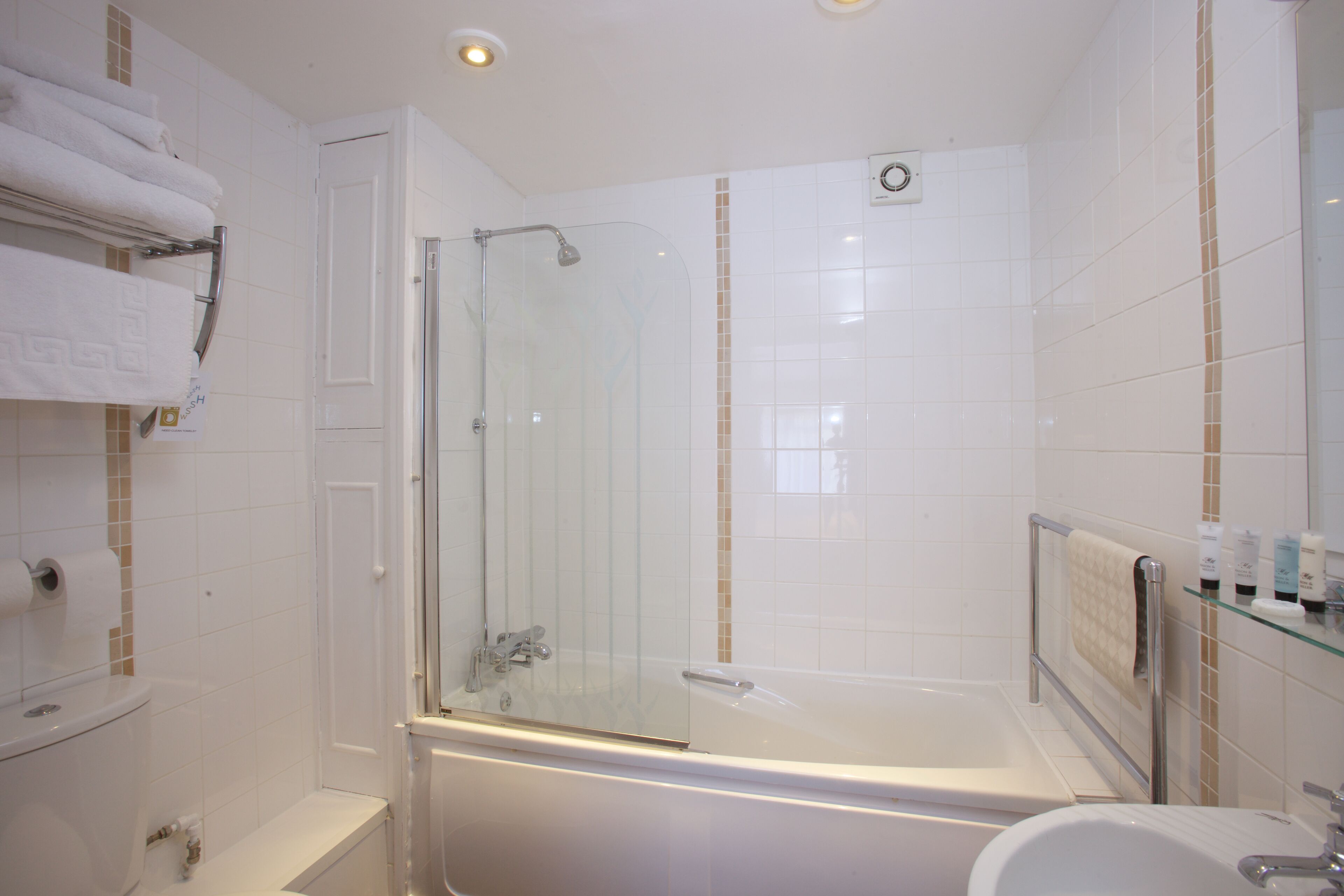 A modern bathroom with a glass-enclosed shower, a bathtub, and a sink.