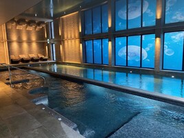 Una piscina cubierta, una piscina al aire libre de temporada, sombrillas