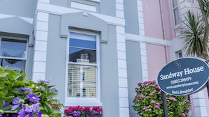 A two-story building with a sign reading "Sandway House." - Sandway House (Torquay)