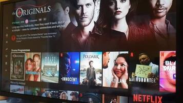 A Netflix interface with various TV show thumbnails.