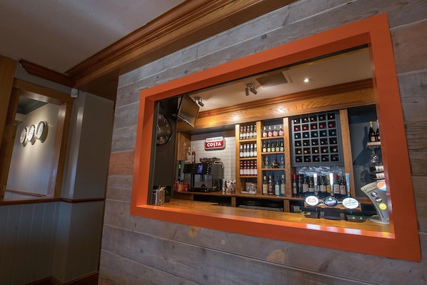 A bar area with a Costa sign, a coffee machine, and a variety of liquor bottles. - Premier Inn Walsall - M6 J10 (Walsall)