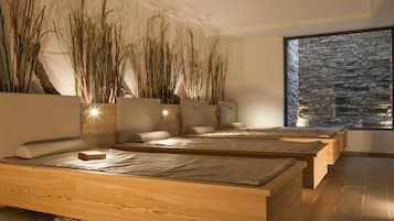 Relax in a serene space with plush beds, lush greenery, and a calming view.