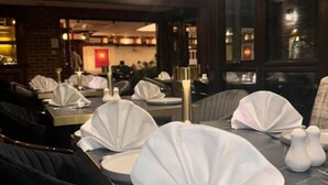A restaurant with tables set with white tablecloths and salt and pepper shakers. - The New Chichester Hotel (Wickford)