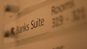 A close-up of a hotel room sign with the text "Banks Suite 319".