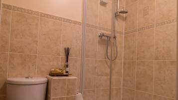 A bathroom with a toilet, a shower, and a bathtub.