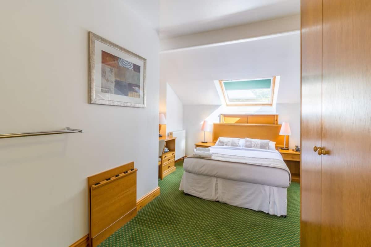 Premium bedding, desk, laptop workspace, blackout drapes