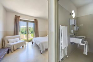 Habitación Deluxe | Baño | Ducha y cabezal de ducha tipo lluvia