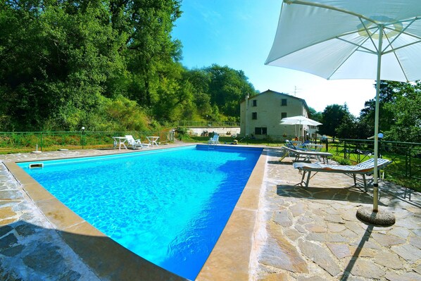 Seasonal outdoor pool, open 10:00 AM to 7:00 PM, pool umbrellas
