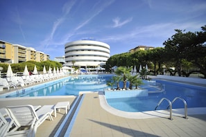 A hotel pool area with lounge chairs, a swimming pool, and a building labeled "hotel Casale."