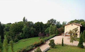 Escape to a serene retreat surrounded by lush greenery and a beautifully maintained lawn.