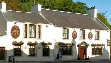 A traditional white building with a sign reading 'The Laird & Dog Inn'.