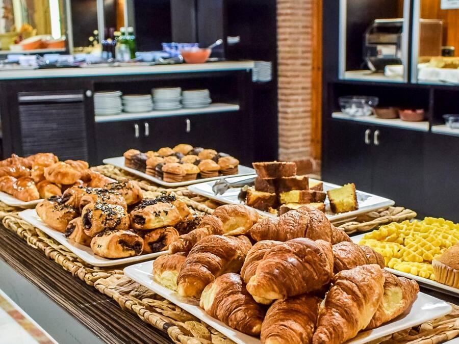 A buffet with various baked goods including croissants and muffins.