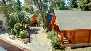 A wooden cabin with a stone pathway leading to the entrance.