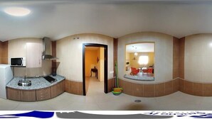 A panoramic view of a hotel room with a kitchen area, a dining area, and a bathroom. - Sancho IV Apartamentos Turísticos Rurales (Cortegana)