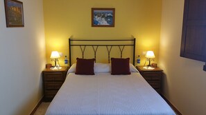 Escritorio, cortinas opacas, tabla de planchar con plancha