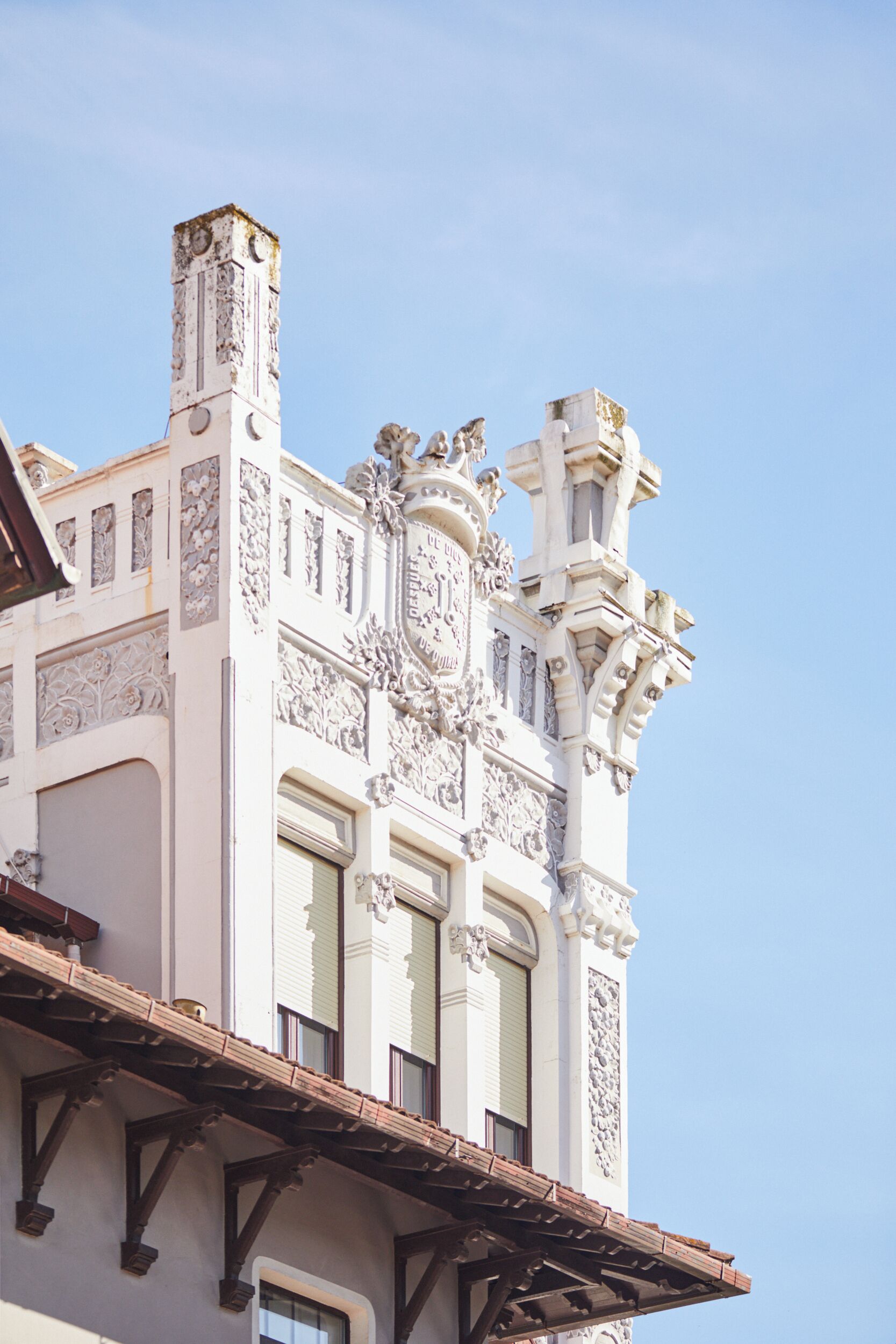 A building with ornate architectural details, including a clock and decorative carvings.