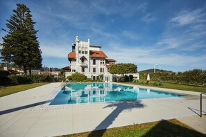 Un edificio grande con una piscina delantera.