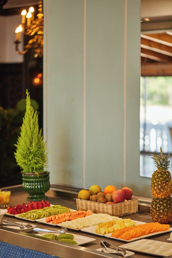 A buffet with various fruits and vegetables.