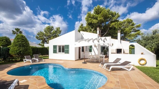 A modern house with a swimming pool, outdoor furniture, and a well-maintained garden. - Villas Geisan (Ciutadella de Menorca)