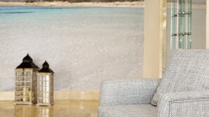 A room with a view of a beach and a small lighthouse model. - Universal Hotel Marqués (Ses Salines)
