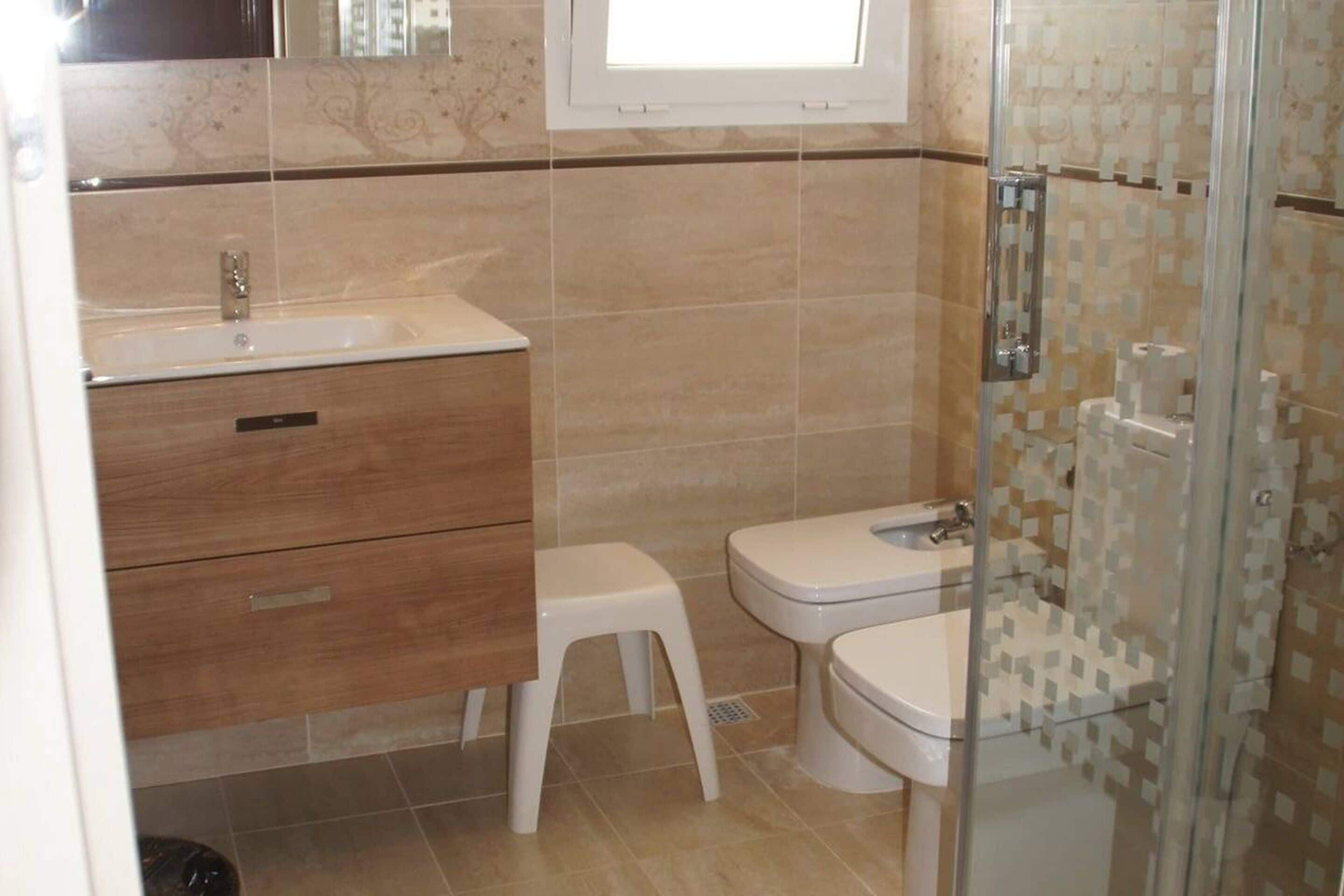 A bathroom with a sink, toilet, and shower.