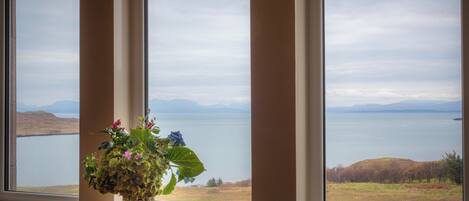 A window with a view of a lake and mountains.