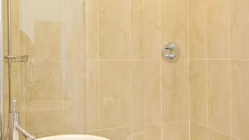 A bathroom with a white sink, a shower, and a bathtub.