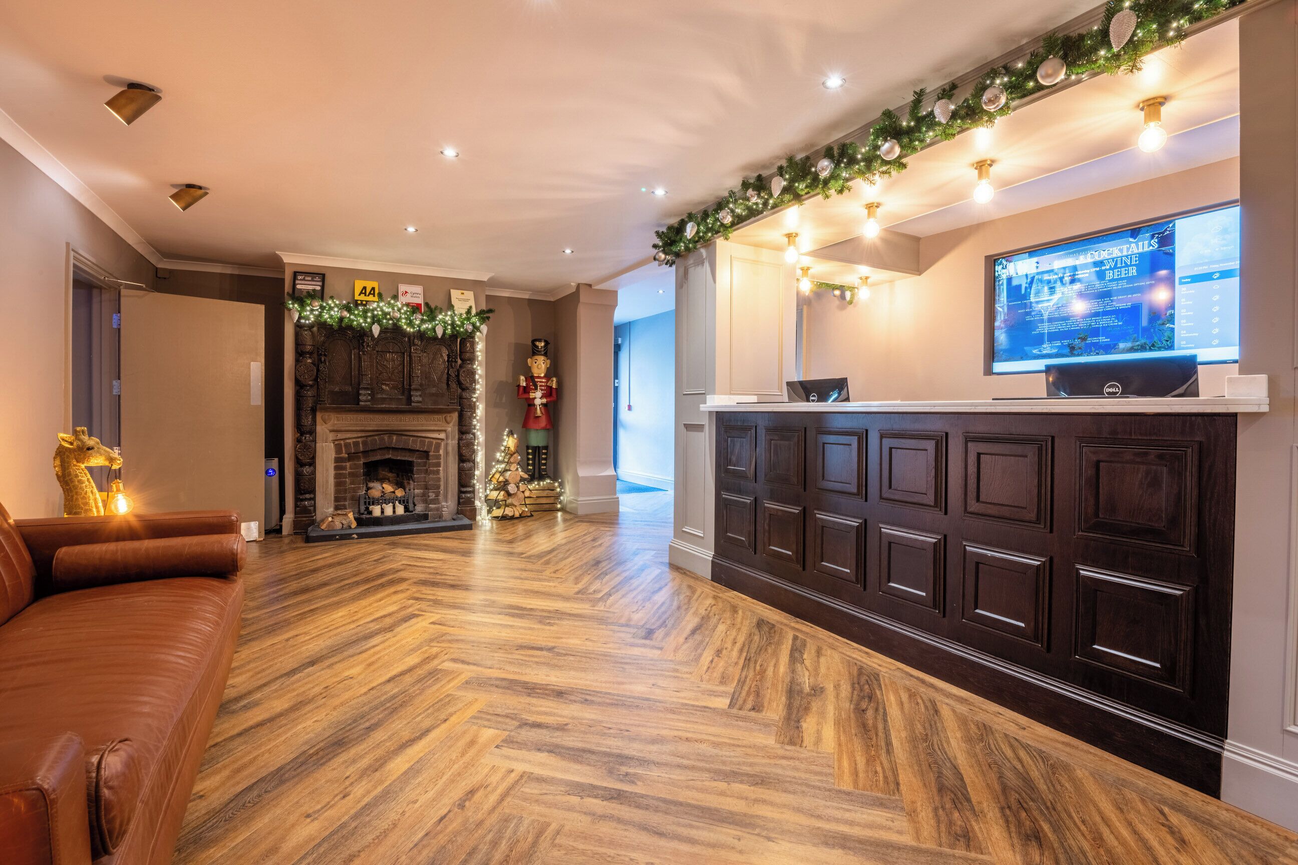 A modern living room with a fireplace, a television, and a wooden floor.
