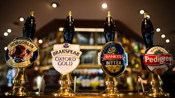 Four beer taps labeled with different brands.