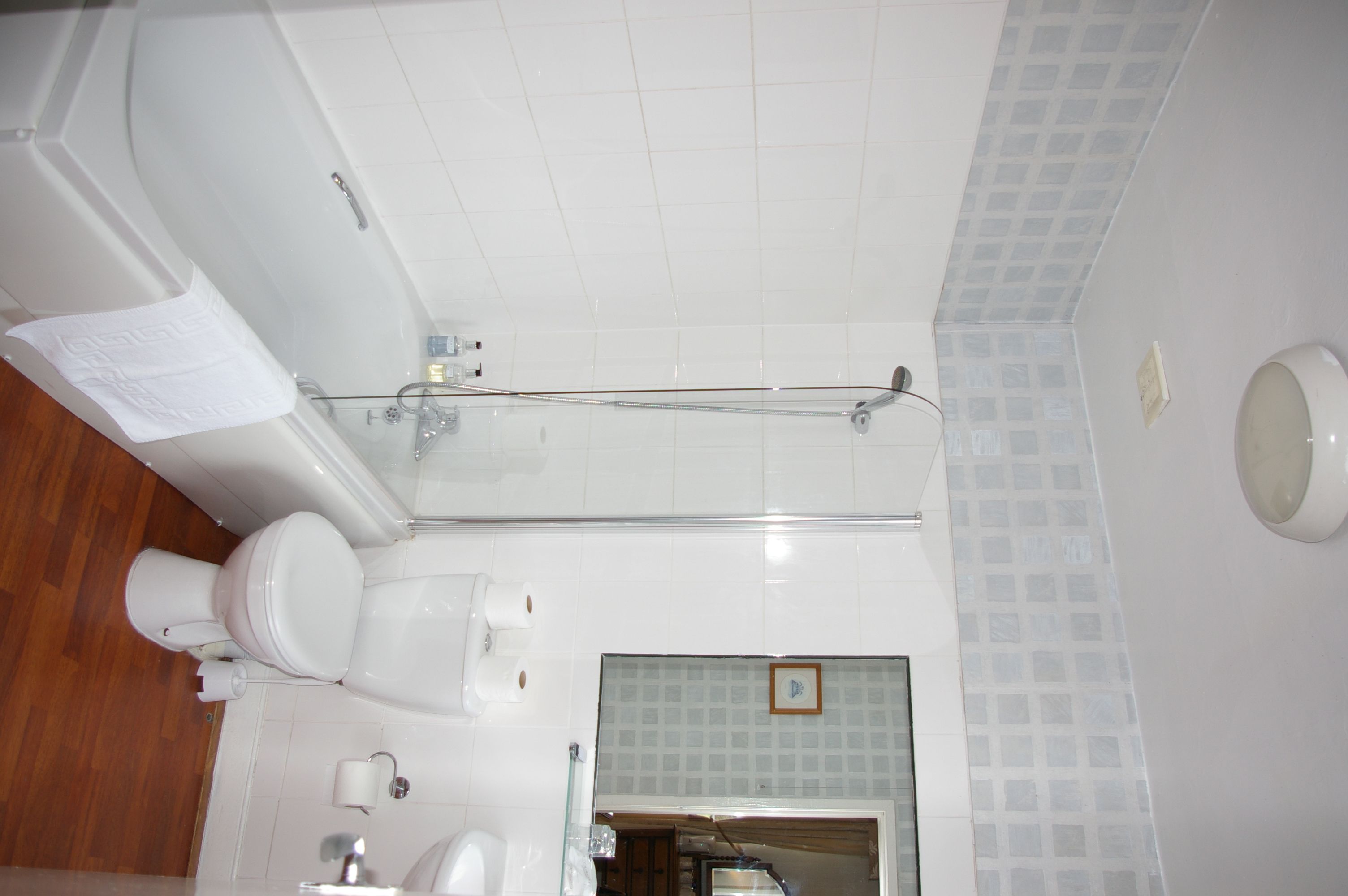 A bathroom with a bathtub, toilet, and sink.