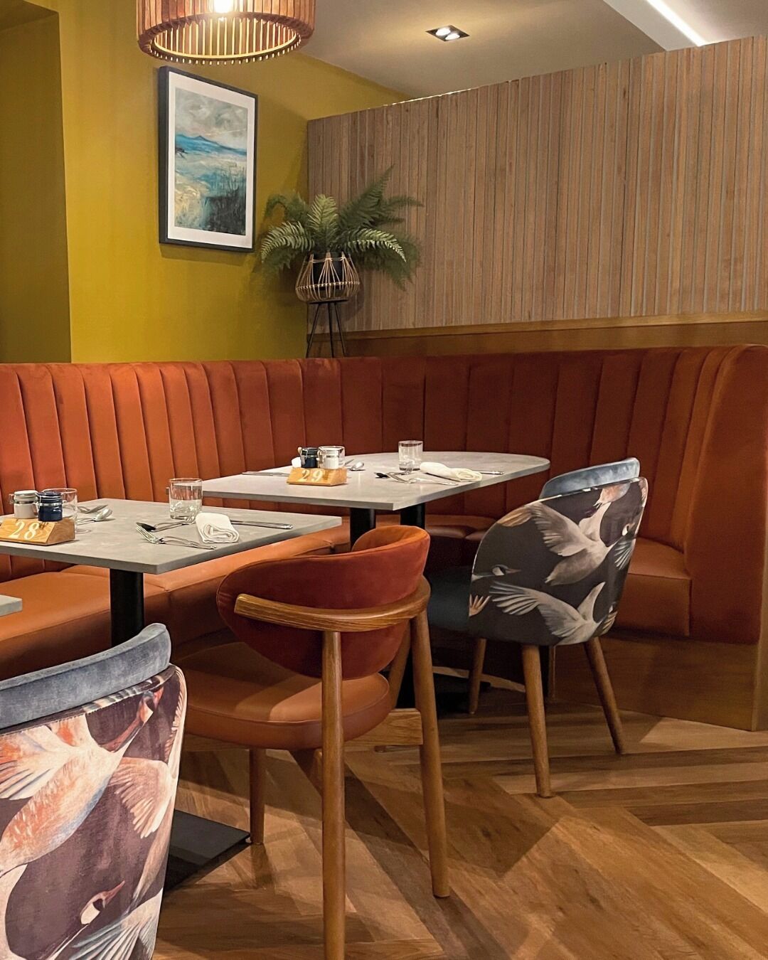 A restaurant interior with booths, tables, and chairs.