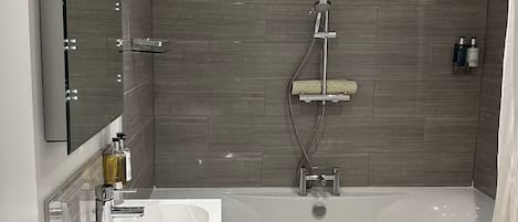 Un baño moderno con bañera, lavabo y ducha.