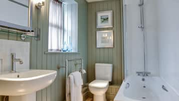 A bathroom with a sink, toilet, and bathtub.